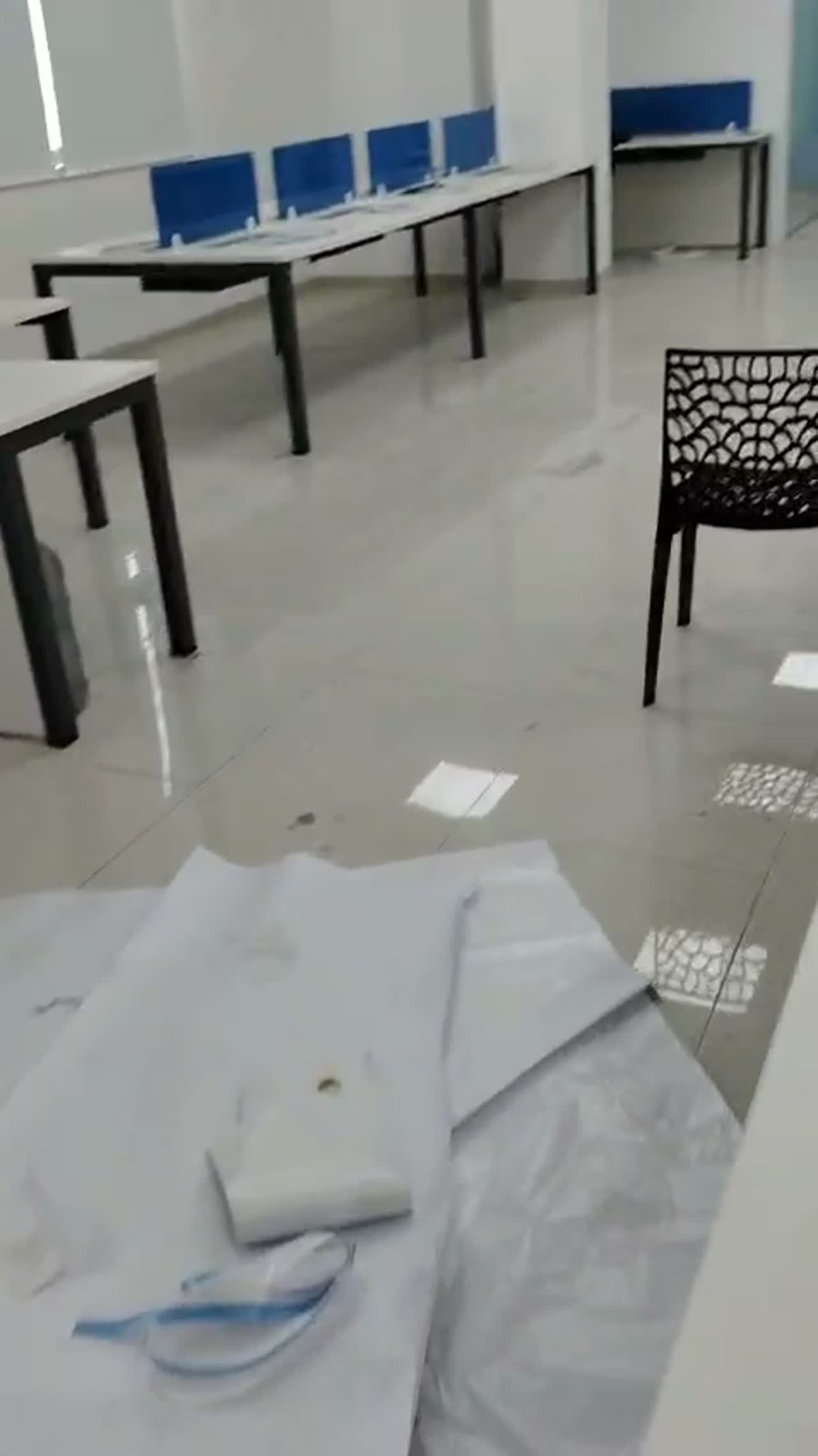 Video of an office cafeteria with a printed coffee-themed wall graphic and lattice-patterned frosted glass doors