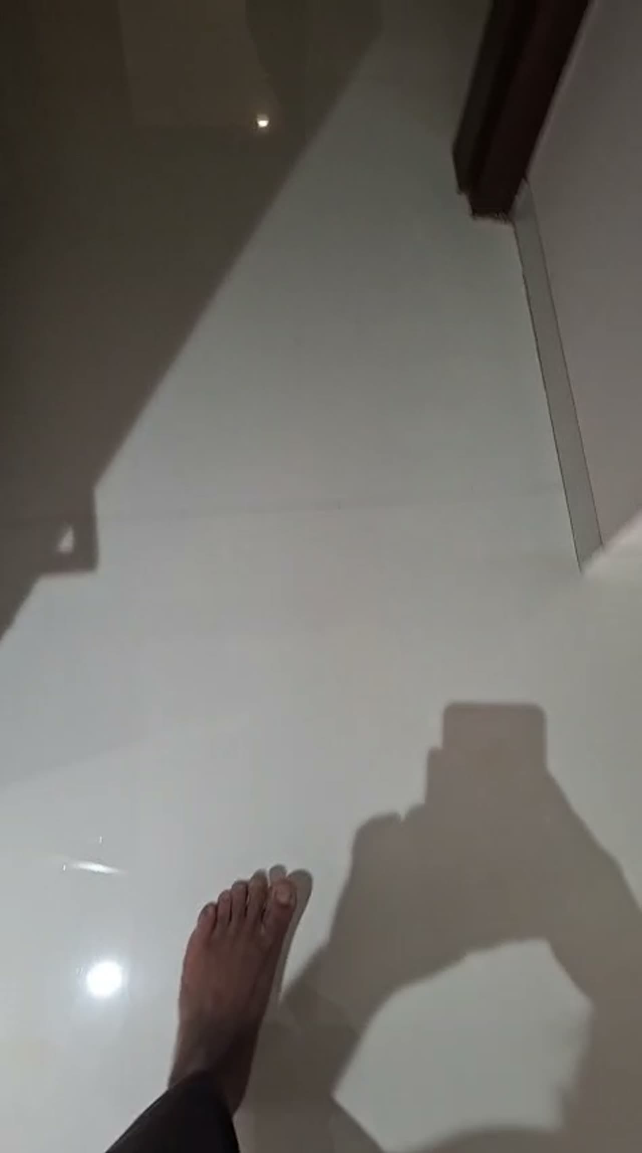 Video of corner bedroom windows covered in textured crystal-pattern privacy film, glowing with diffused daylight