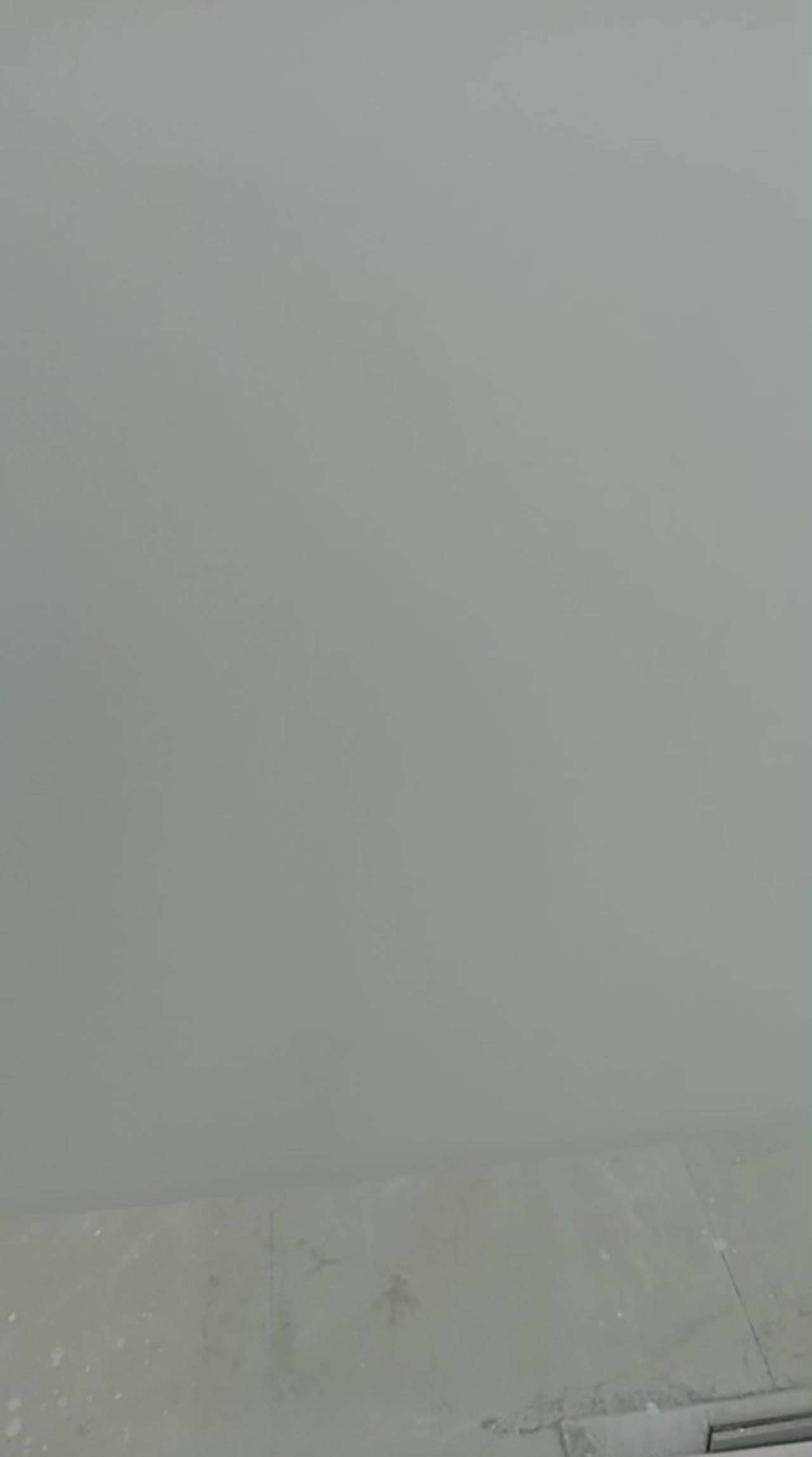 Video of frosted glass partitions in a high-rise office under construction, city skyline visible through the far window