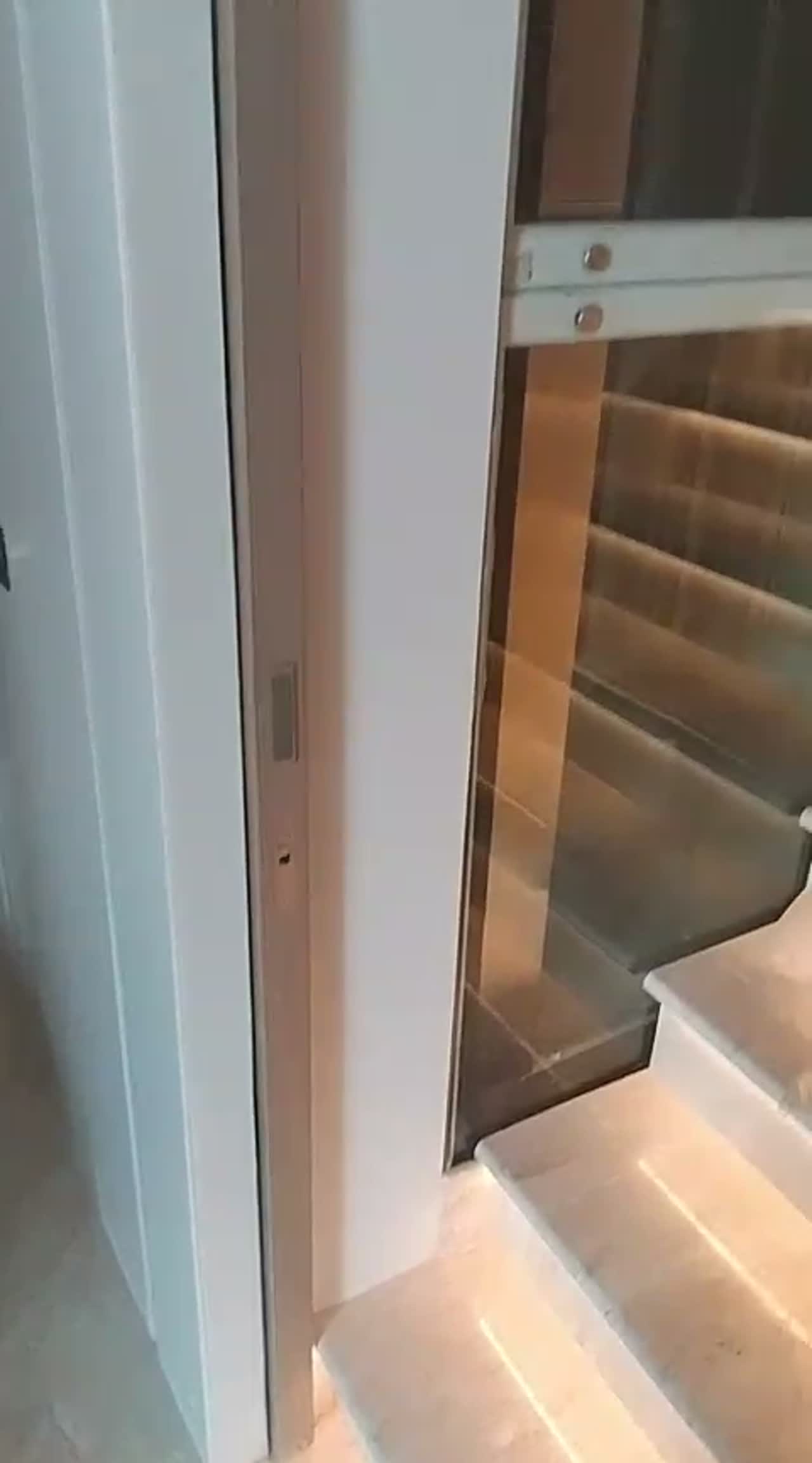 Video of a frosted glass balustrade panel alongside an illuminated marble staircase in a residence