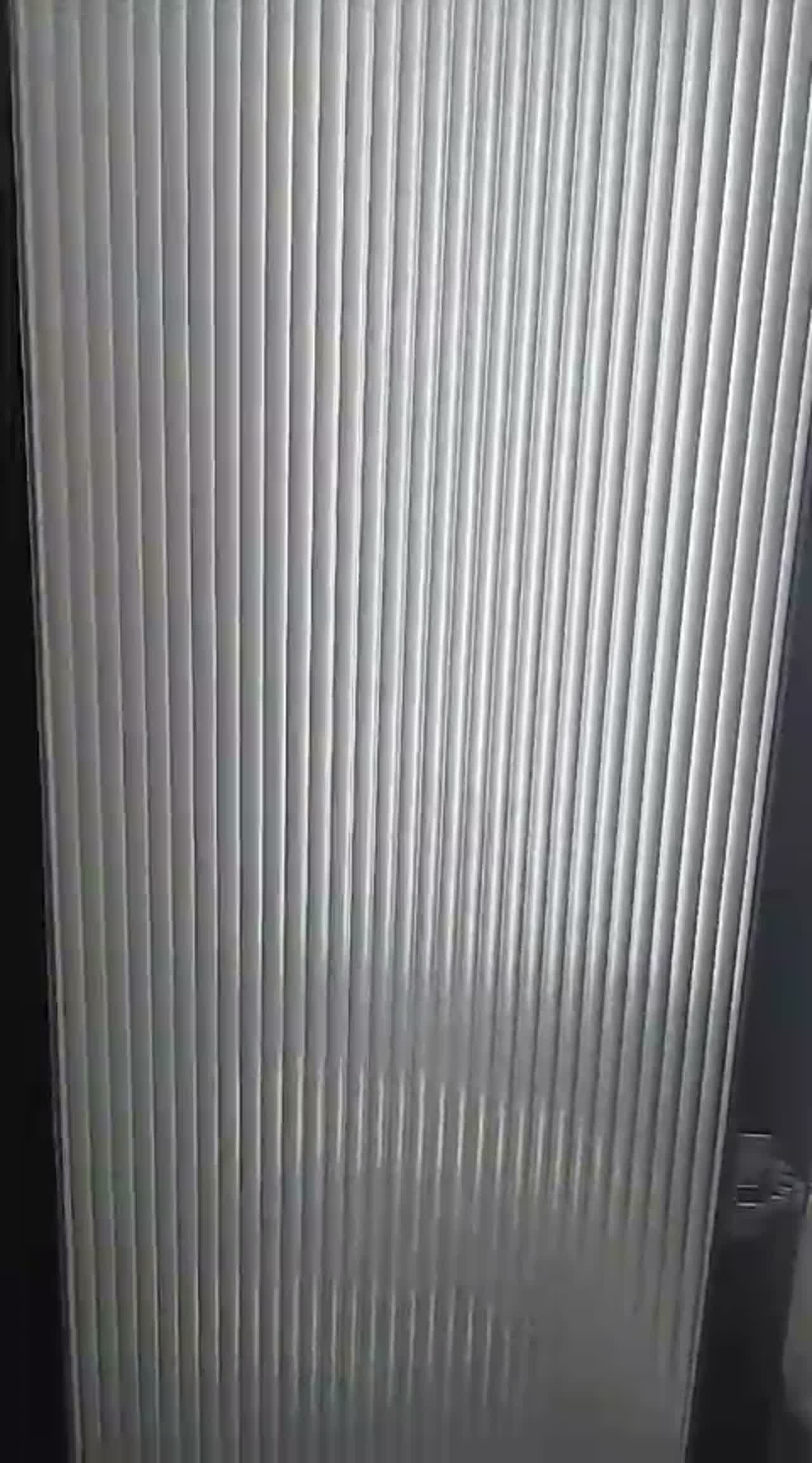 Detail video of vertical reeded film texture filling a single glass door leaf